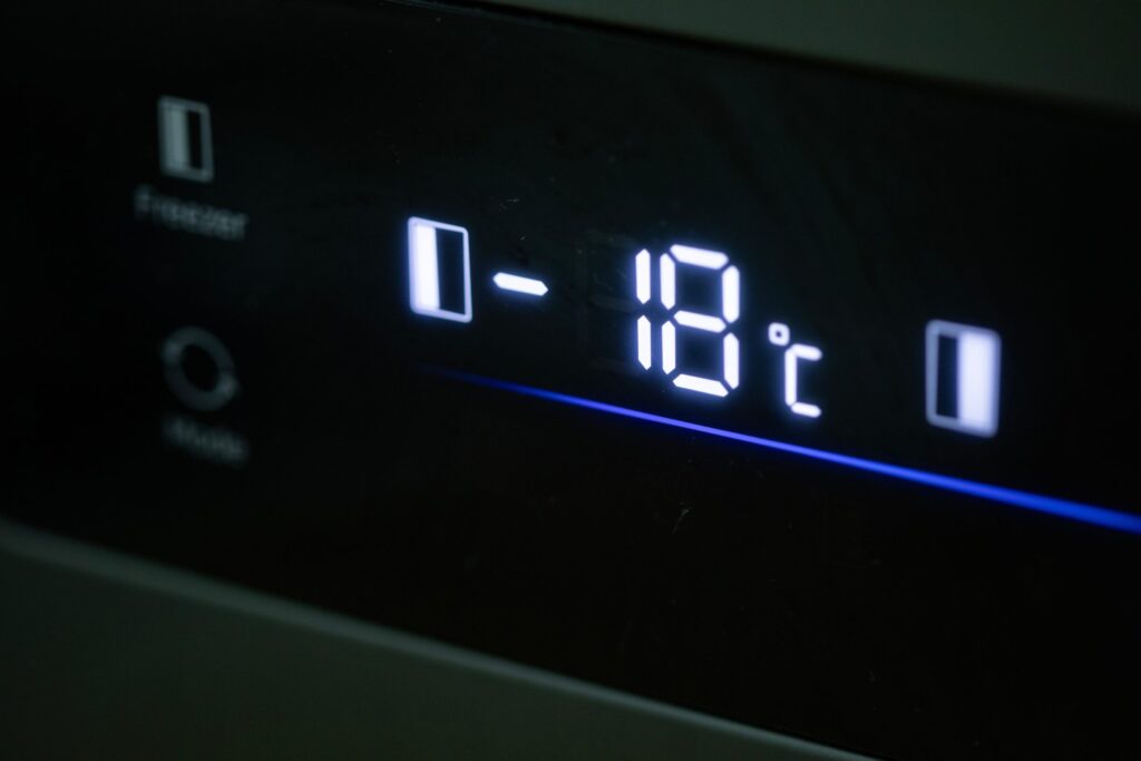 A close up of a freezer temperature display reading -18 degrees C.