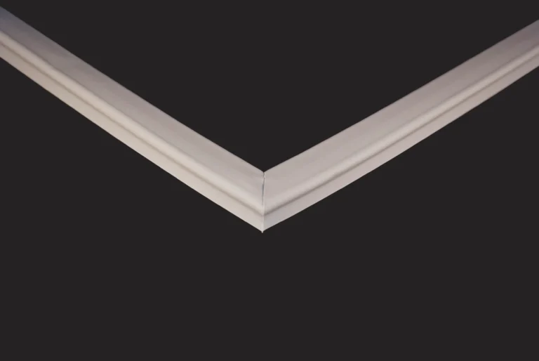 A sharp, close-up view of two Dalmec PPCS 703 Door Seals meeting at a precise 90-degree corner against a smooth black background, highlighting the clean lines and geometric contrast between the seals and the dark space.